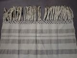 an image of a white and gray towel with fringes on it