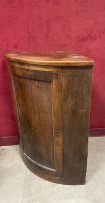 a small wooden cabinet with a door on it