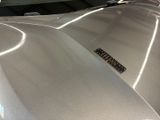 a close up of a shiny car with a sticker on the hood