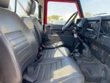 the interior of a red jeep with black leather seats and a steering wheel