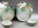 two vases and a bowl sitting on a table