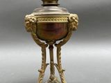 an antique brass vase with a crown on top of it