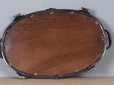 a drum on a table with a white wall in the background