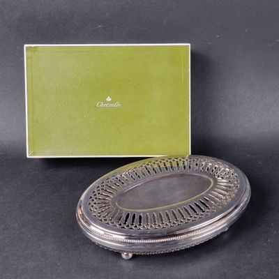 a silver plate with a green box in the background