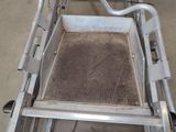 a picture of a metal cart with dirt inside of it