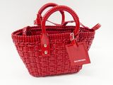a red basket bag with a tag attached to it