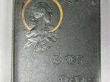 an old black book with a picture of a woman on it