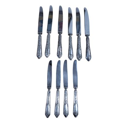 a set of six silverplated knives and a knife on a white background