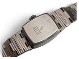 an image of a close up of a wrist watch on a white surface