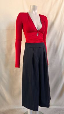 a mannequin wearing a red top and black skirt
