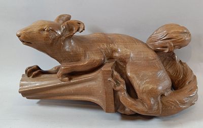 a wooden sculpture of a dog laying on a bench