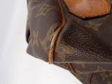 a close up of a louis vuitton bag on a white surface