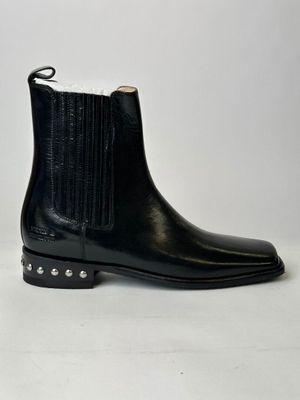 a pair of black leather boots with studded sides on a white background