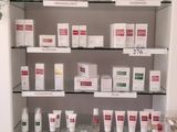 a display of skin care products on a glass shelf
