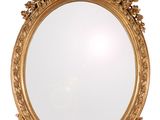 a gold mirror on a white wall with a white background