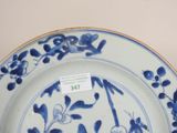 a blue and white plate with flowers and birds on it