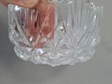 a hand that is holding a small glass bowl