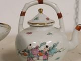 a tea pot and a bowl sitting on a table