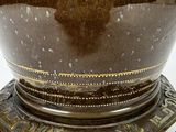 a vase that is sitting on a stand on a table