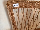 a wicker chair that has a price tag on it
