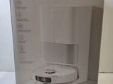 the box is open on a white table with a black and white picture of a coffee maker in it