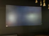 a flat screen tv hanging on the wall in a room