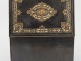 an antique black and gold decorated desk with a drawer on wheels