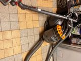 a vacuum that is sitting on the floor next to a dishwasher