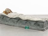 a statue of a person laying on a bed