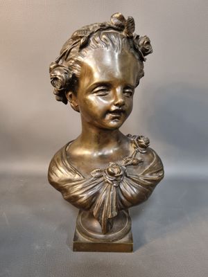 bronze bust of a young girl with a flower in her hair