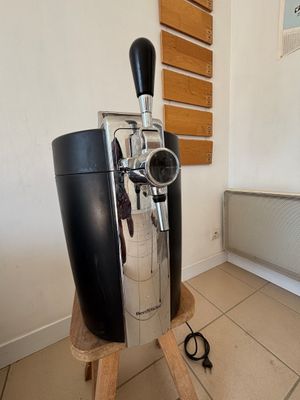 une photo d'une machine à café posée sur un support dans une pièce