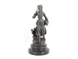 a statue of a man riding a horse with a dog