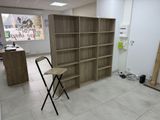 a chair that is sitting in front of a bookshelf