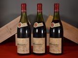 three bottles of wine sitting on a table next to a wooden box