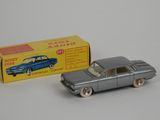 an old toy car and box of toys on a white surface