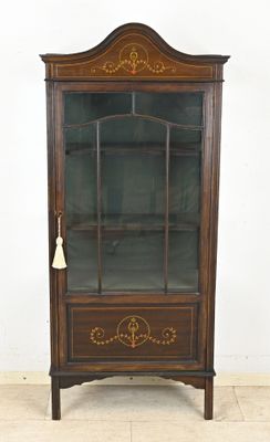 an old wooden cabinet with a glass door and a bell on the top