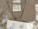 a brown shirt wrapped in plastic and a pair of scissors