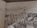 an open book with a drawing of a castle on it