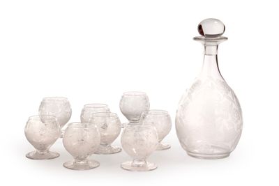 bottles and glasses are lined up in a row on a white surface