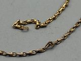 a close up of a gold chain with a clasp on it
