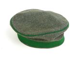 a green hat on a white surface with a white background