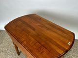 the table is made of wood and has a curved top