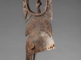 a wooden sculpture of a woman ' s head on a stand
