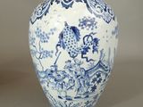 a blue and white vase sitting on a table