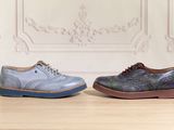 pair of blue and purple shoes sitting on top of a wooden table