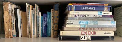 many books that are stacked on a shelf together