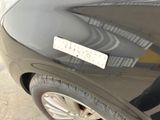 a black car with a sticker on the side of it