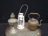 a metal tray with a teapot and a tea kettle on it