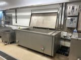 many stainless steel sinks in a large commercial kitchen