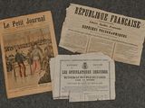 Plusieurs journaux sont posés les uns à côté des autres sur une table.